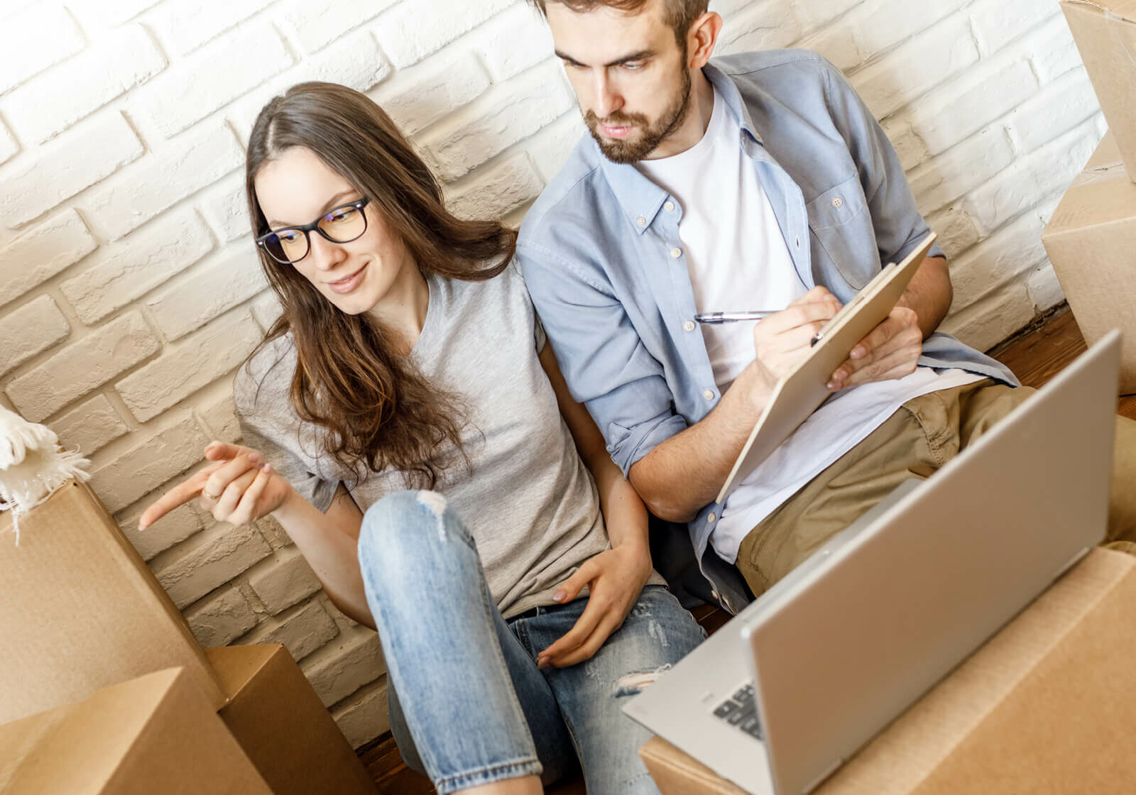 Couple sitting on the floor | America's Flooring Store