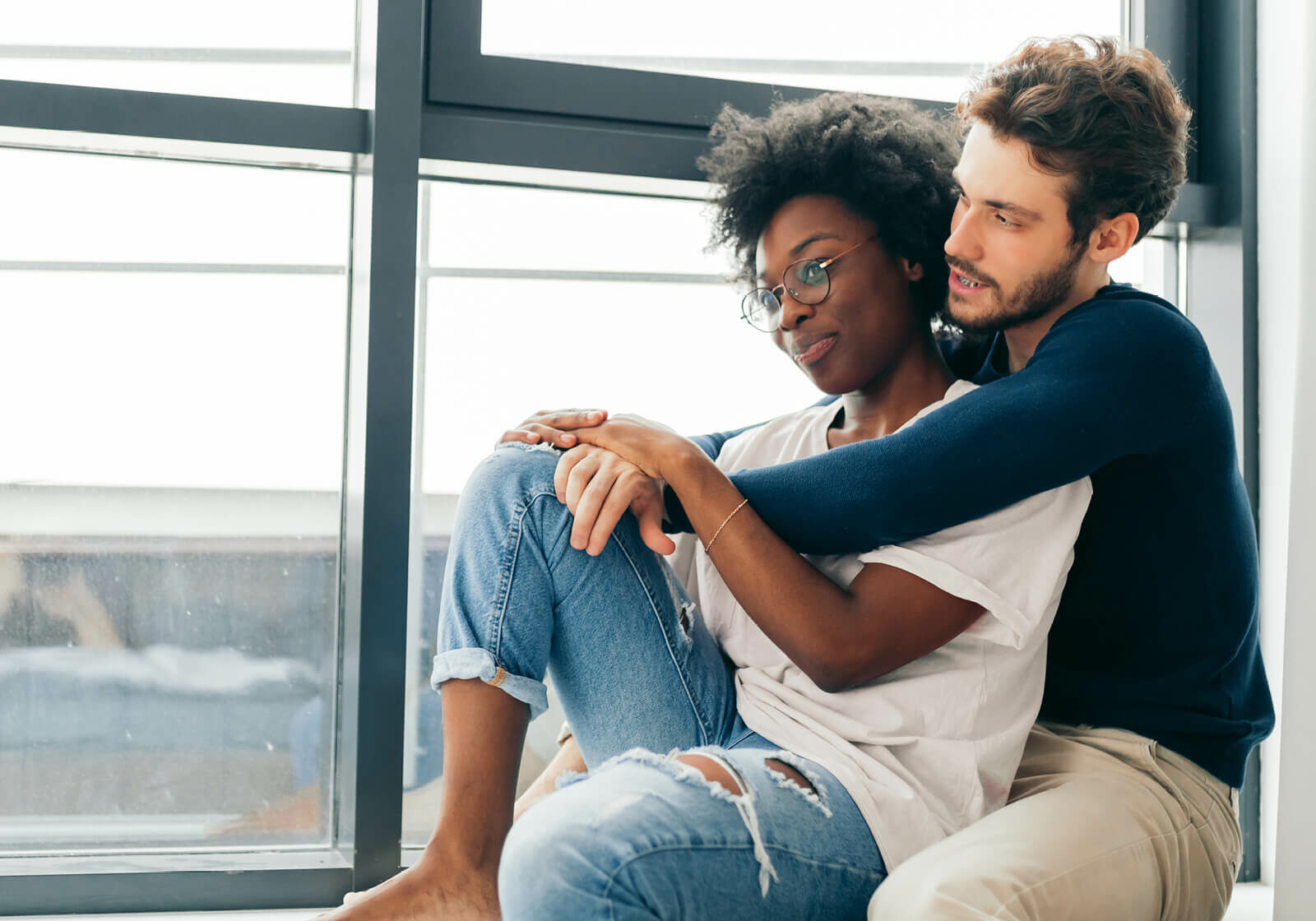 Couple sitting by a window | America's Flooring Store