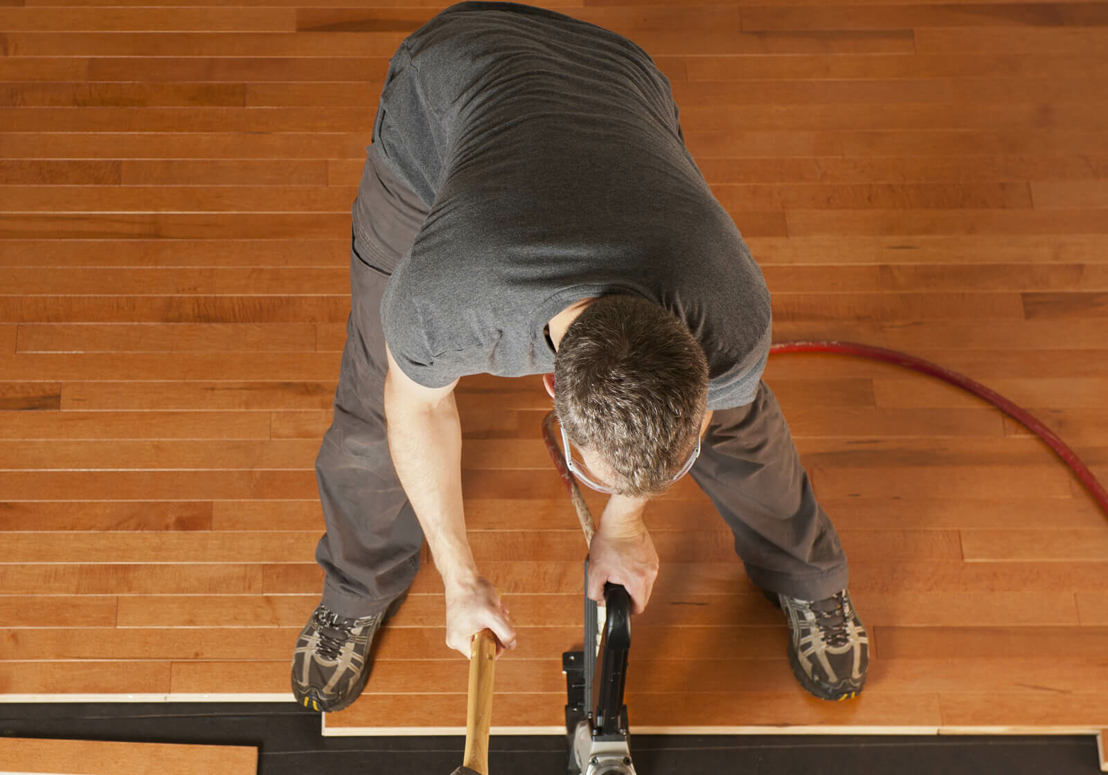 Man installing hardwood | America's Flooring Store
