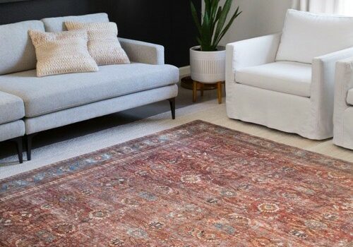 Area rug on carpeted floor | America's Flooring Store