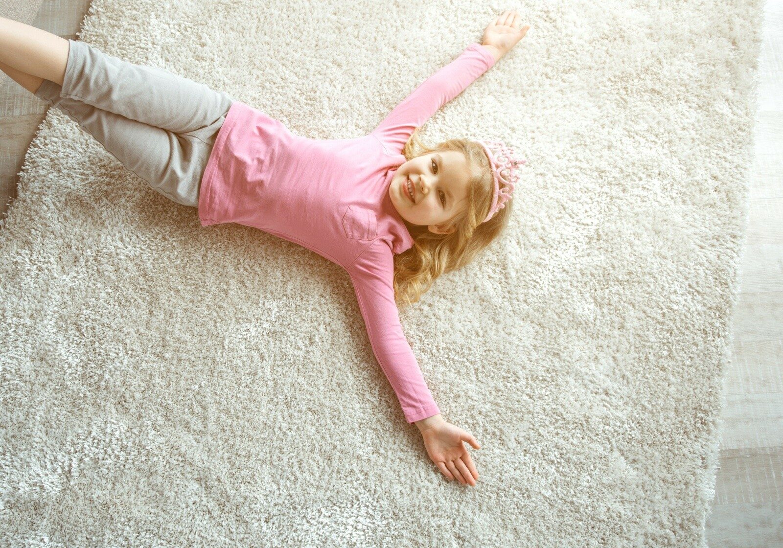 Child lying on carpet | America's Flooring Store