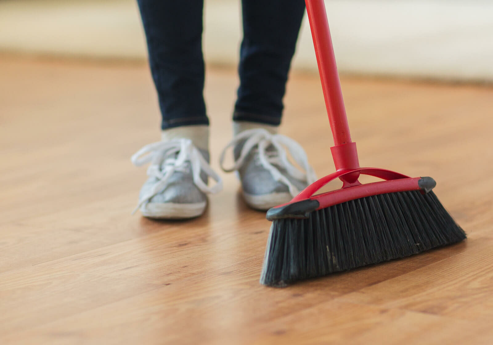 Floor being cleaned with a broom | America's Flooring Store