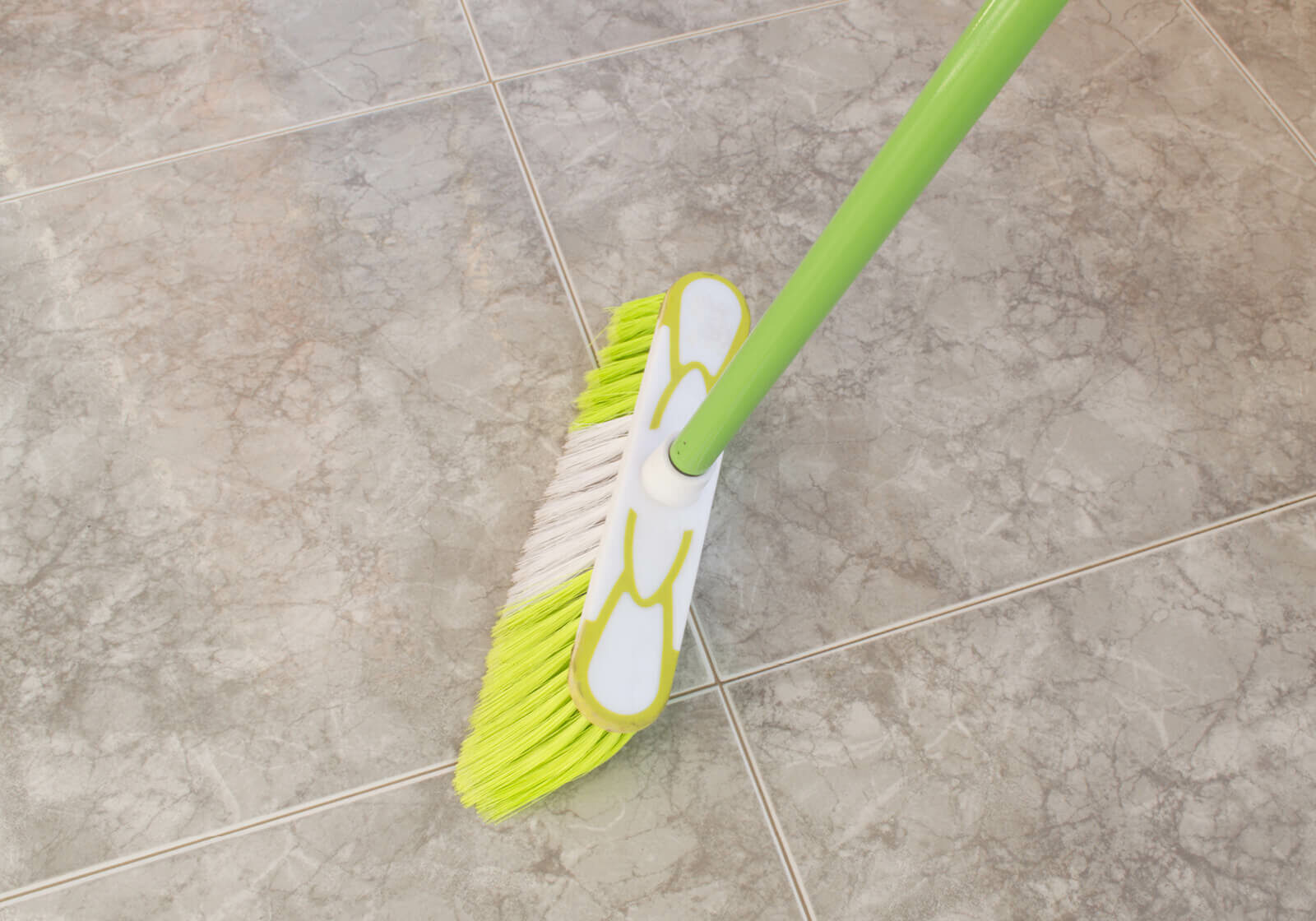 Broom on tile floor | America's Flooring Store